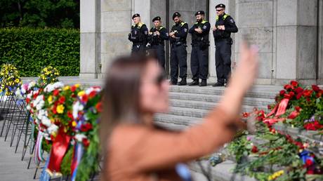 Police officers observe the events at the Soviet memorial in Tiergarten, Berlin, Germany, May 9, 2025