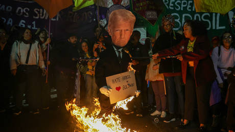FILE PHOTO. Protesters set fire to an effigy of Trump at a rally in Sao Paulo, Brazil.