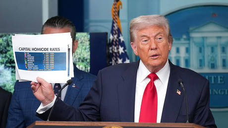 US President Donald Trump shows crime statistics during a press conference on August 11, 2025 in Washington, DC.
