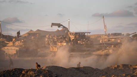 Israeli soldiers operate tanks near the northern borders of Gaza on August 18, 2025.