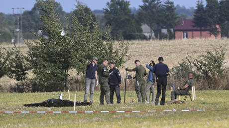 Police and Military Police secure parts of a damaged UAV shot down by Polish authorities at a site in Wohyn, Poland, Wednesday, Sept. 10, 2025.