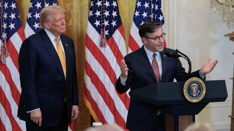 US President Donald Trump (L) looks on as House Speaker Mike Johnson (R) speaks, White House, Washington, DC. July 22, 2025.