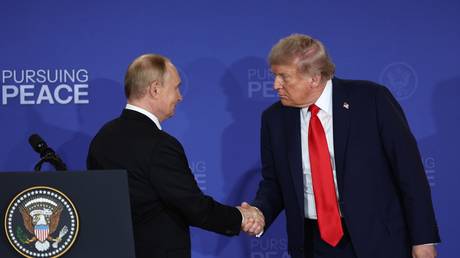 FILE PHOTO: Russian President Vladimir Putin (L) and US President Donald Trump (R) shake hands at a summit in Alaska, US, on August 15, 2025.