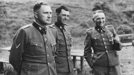 Dr. Josef Mengele (C) socializes with other Nazi officers outside Auschwitz concentration camp in 1944.