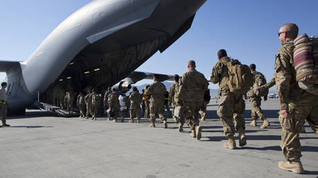 FILE PHOTO: US Army soldiers walk to their plane at Bagram Air Base, Afghanistan.