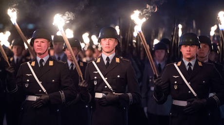 FILE PHOTO. German soldiers hold torches during the Großer Zapfenstreich military ceremony honoring Chief of Staff General Volker Wieker at the Defense Ministry in Berlin, Germany, April 18, 2018.