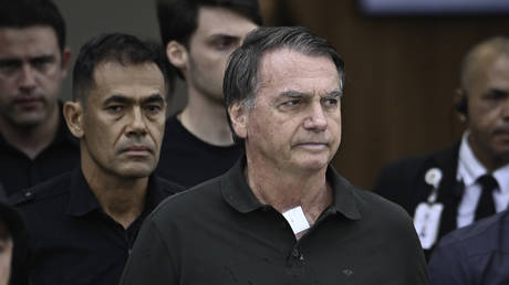 FILE PHOTO: Former Brazilian president Jair Bolsonaro being escorted by police.