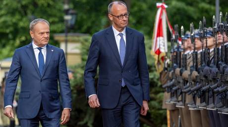 German Chancellor Friedrich Merz and Polish Prime Minister Donald Tusk at a welcoming ceremony in Warsaw.