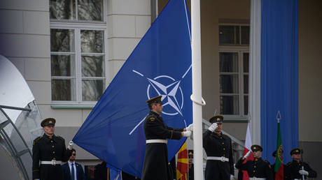 Lithuanian soldiers raise the NATO flag in front of the Presidential Palace in Vilnius, on March 29, 2024.