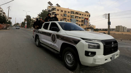 FILE PHOTO. Servicemen with Syrian security forces ride a pickup truck.