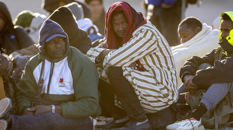 FILE PHOTO. Immigrants wait to be transported from the US-Mexico border in Lukeville, Arizona.