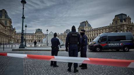FILE PHOTO: French Police officers seal off the entrance to the Louvre Museum after a Jewllery Heist on October 19, 2025 in Paris, France.