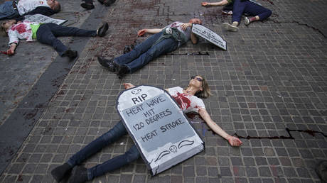 FILE PHOTO: Environmental activists participate in a die-in during a rally for action against climate change in the Financial District in New York City.