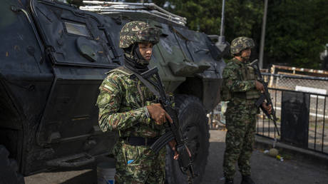 Colombian soldiers stand guard at the Colombia-Venezuela border after the confirmation of Nicolas Maduro's abduction in Caracas, on January 3, 2026.