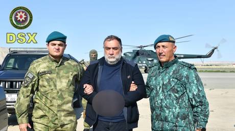 FILE PHOTO: Former State Minister of Nagorno-Karabakh and businessman Ruben Vardanyan is accompanied by Azerbaijani law enforcement officers.